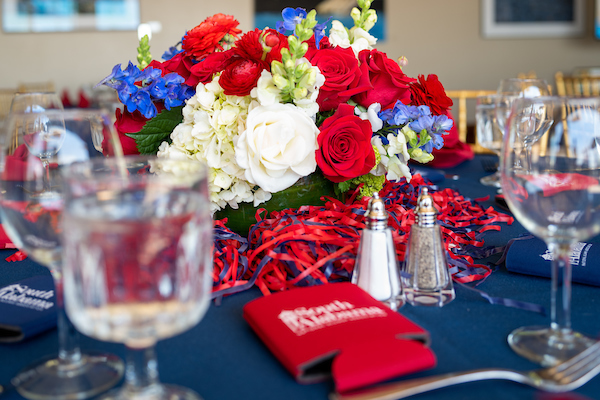 Table decorations including flowers and glasses.