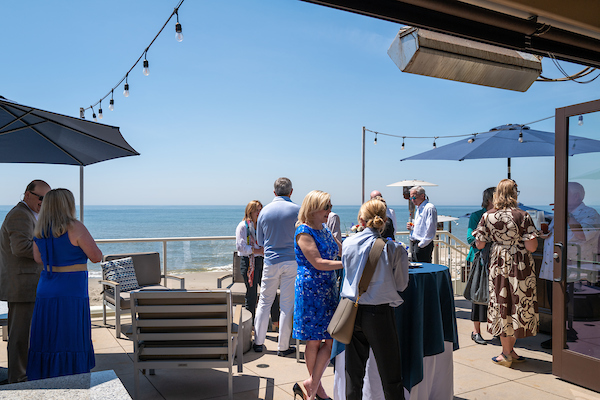 Outside patio with water in the background at alumni event.