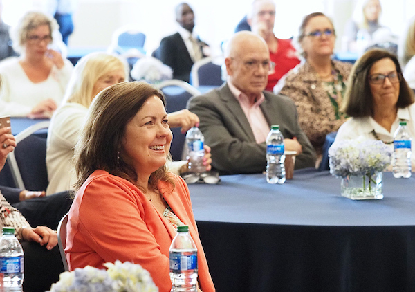 closeup of attendees listening in on the presentation