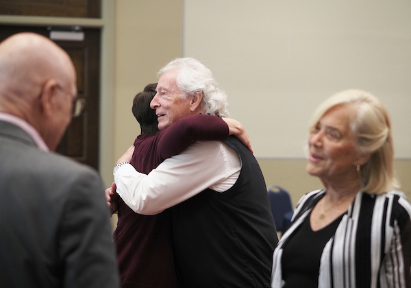 Richard Hayes hugging an attendee