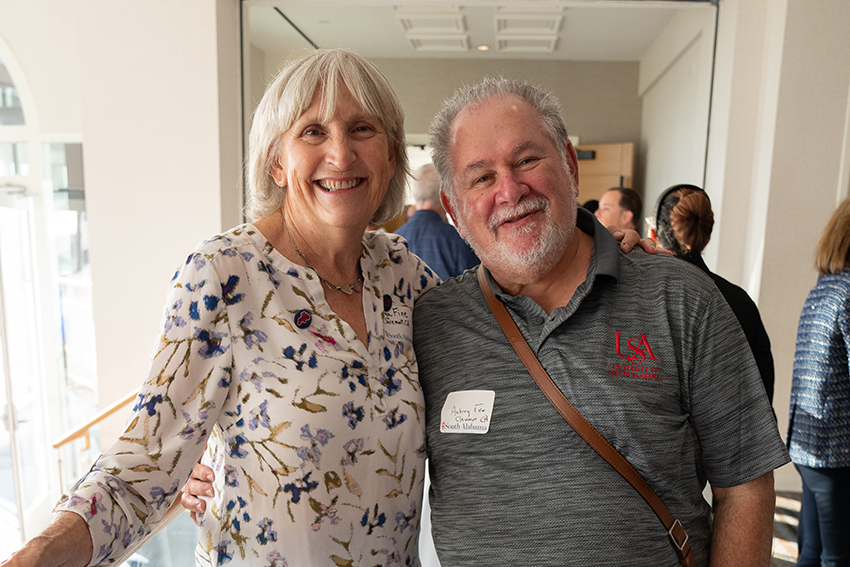 Couple at event with man with USA shirt on.