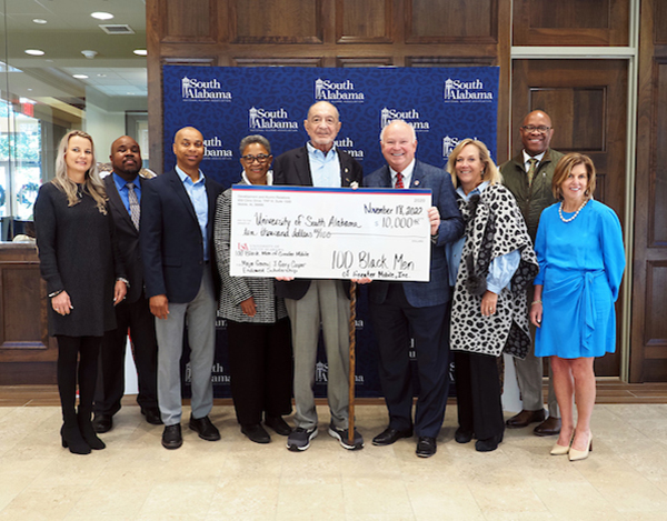 100 Black Men presenting check donation to USA's Margaret Sullivan, Dr. Andi Kent, Dr. Mike Mitchell, Dr. Andre Greene, and President Bonner.