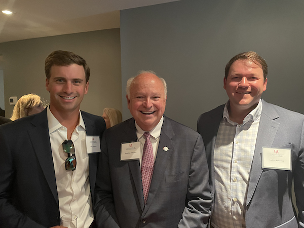 President Jo Bonner with South Alabama alumni's smiling for a picture.