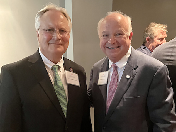 President Jo Bonner with an alumnus smiling for a picture.