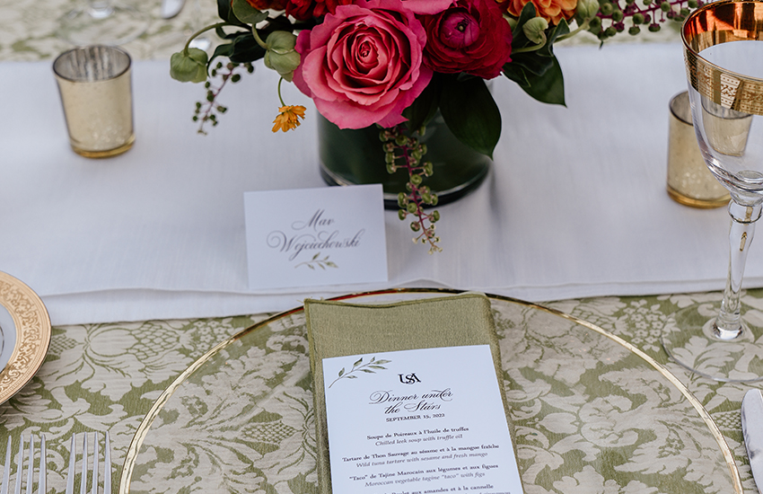 Table setting displaying flowers and place cards.