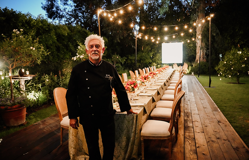 Chef standing in front of the dinner table.