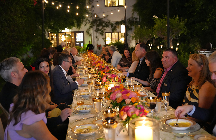 Long shot of everyone at dinner table.