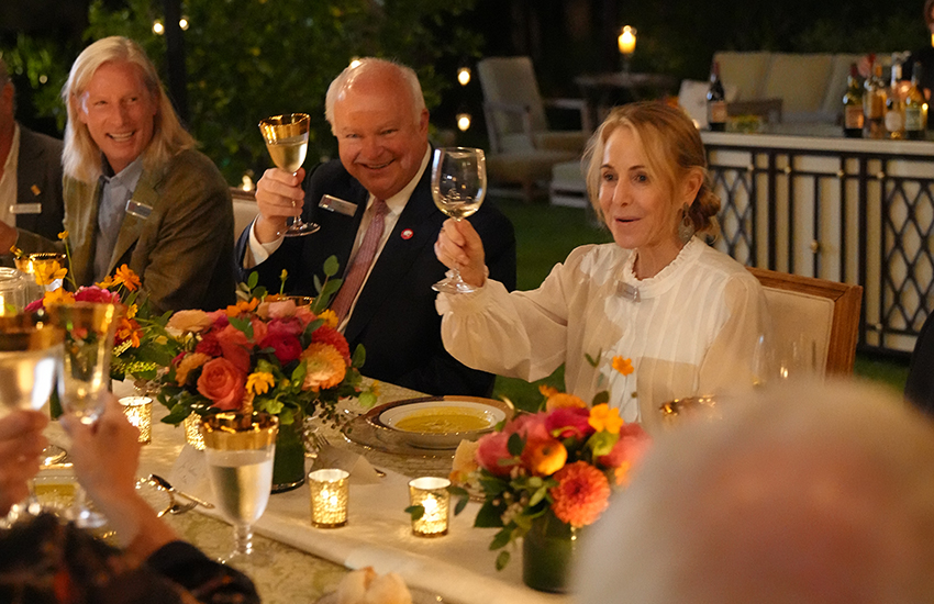 President Bonner and other alumni raising their glass for a toast.