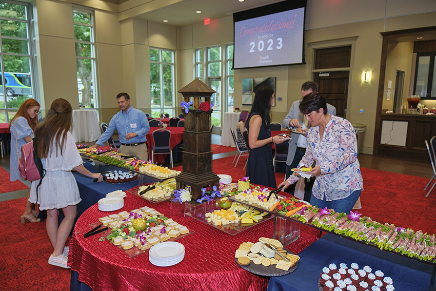 Attendees grabbing refreshments at the Champagne Toast