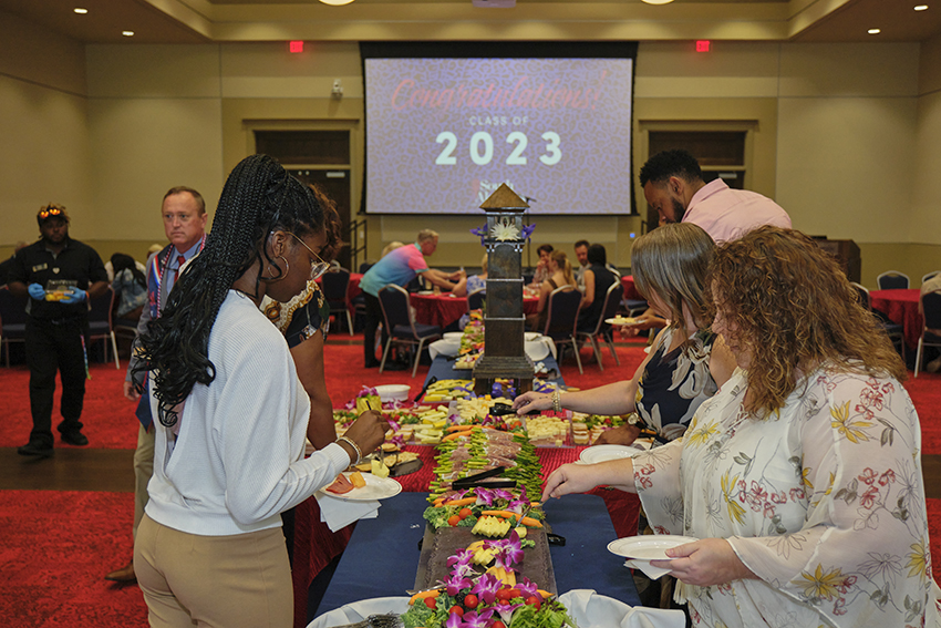 Attendees grabbing refreshments at the Champagne Toast