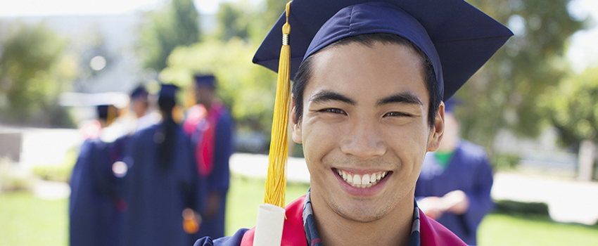 Native American student in cap and gown.