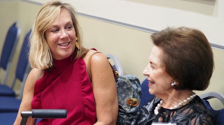 First Lady smiling at Arlene Mitchell.