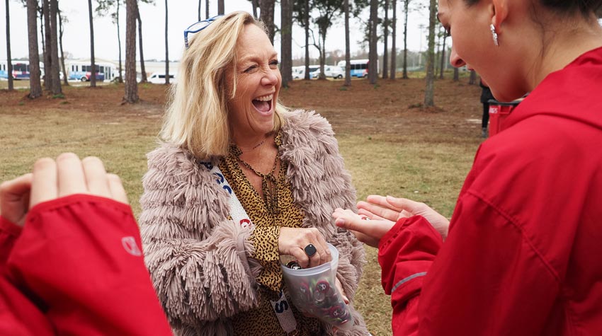 First Lady laughing and handing out buttons.