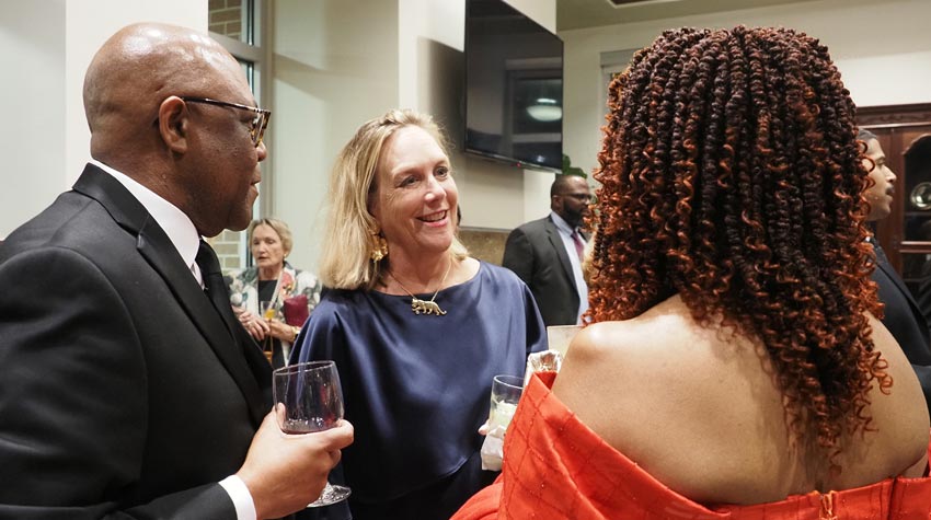 First Lady at event speaking to two people.