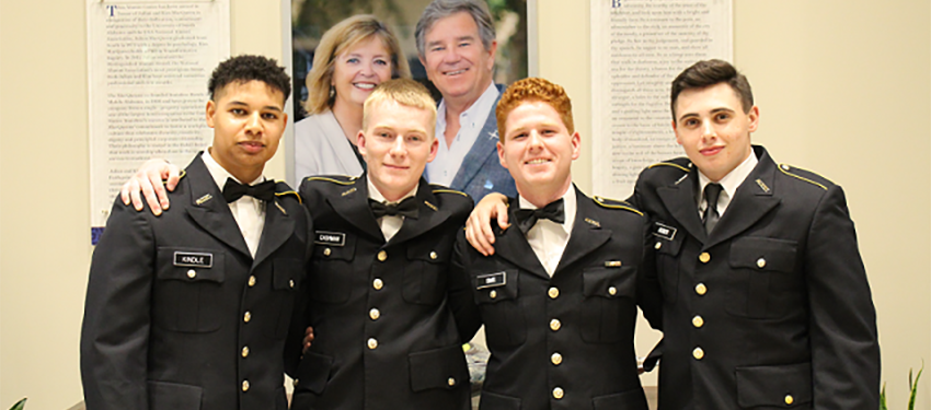 four cadets in dress uniform