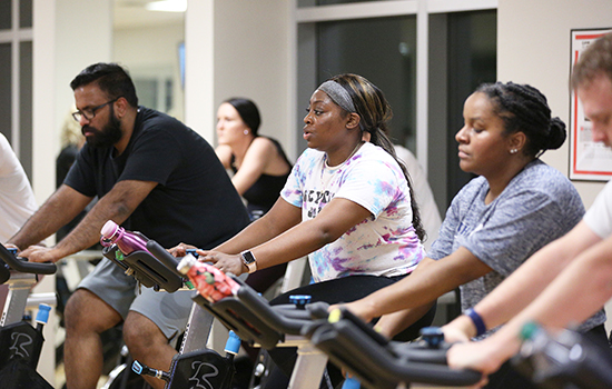 People on bikes in spin class.