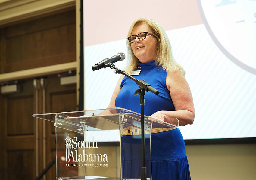 Karen Edwards speaking at podium.