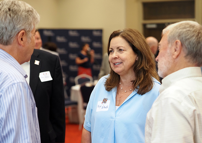 Dr. Paige Vitulli talking at a alumni event.