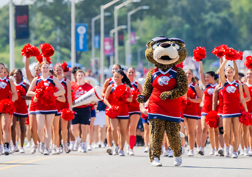 Cheerleaders and the University of South Alabama's mascot cheering.