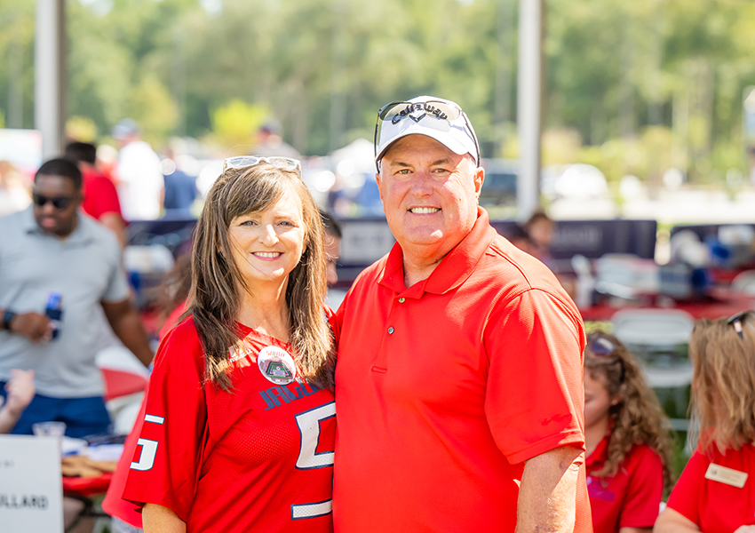 Two alumni smiling.