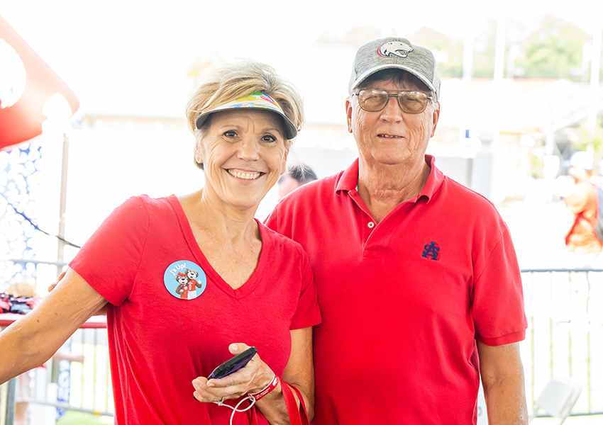 Two alumni smiling.