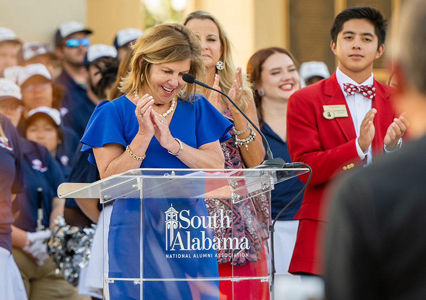 Margaret Sullivan clapping on stage.