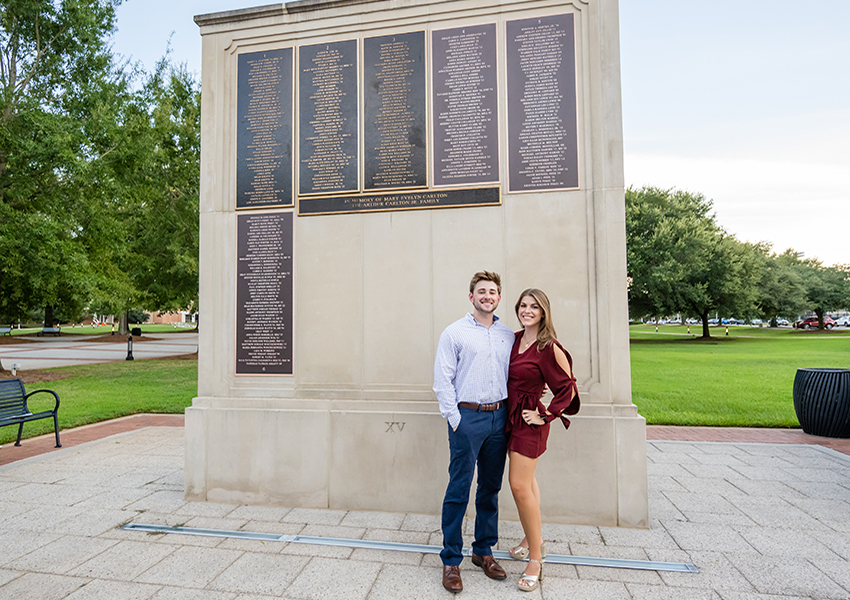 Couple standing in front of Wall of Honor.