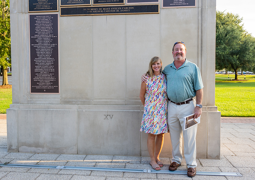 Couple in front of Wall of Honor.