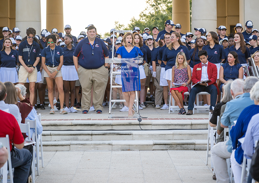 Margaret Sullivan speaking in front of Moulton Tower.