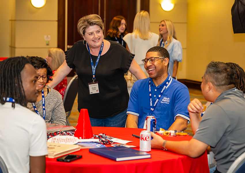 A group of alumni around a table.