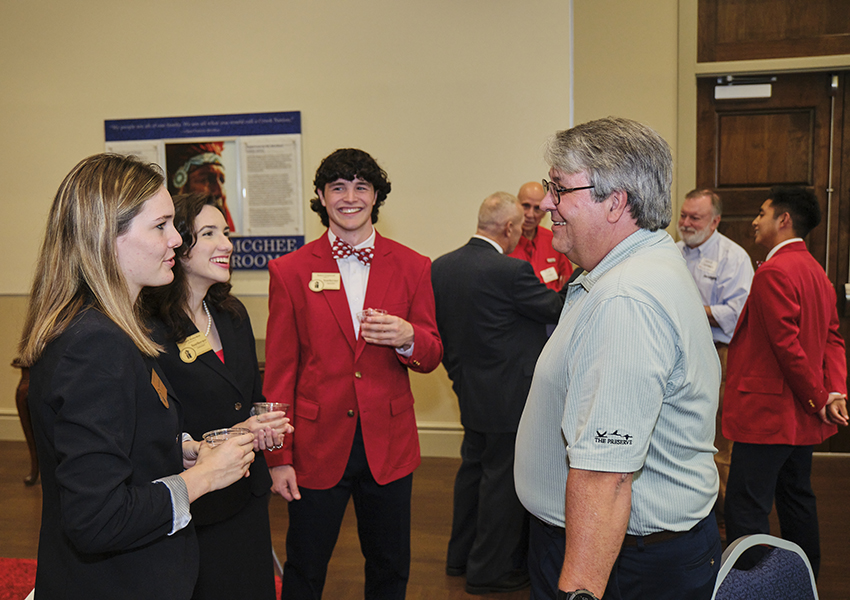 Four alumni talking.