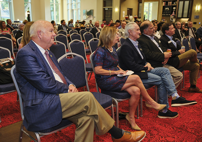 A group of alumni watching a presentation.