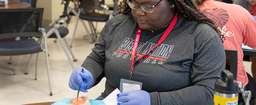 Student working on prosthetic. .