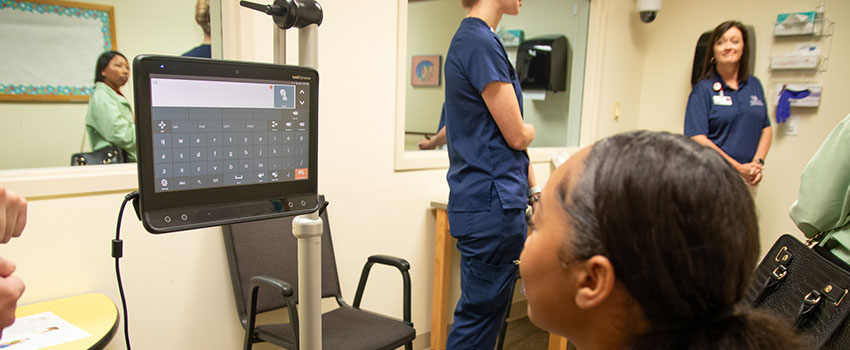 Student looking at monitor reading health information.