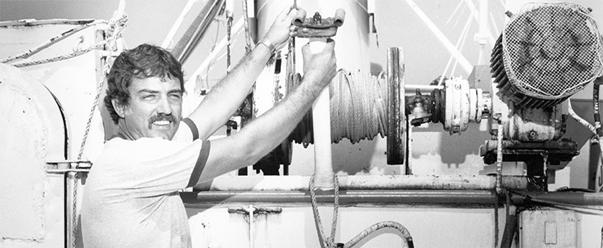 Old black and white photo of Dr. Shipp in a lab working on equipment.