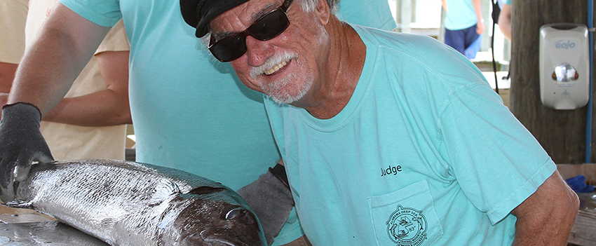 Dr. Shipp smiling with a fish.