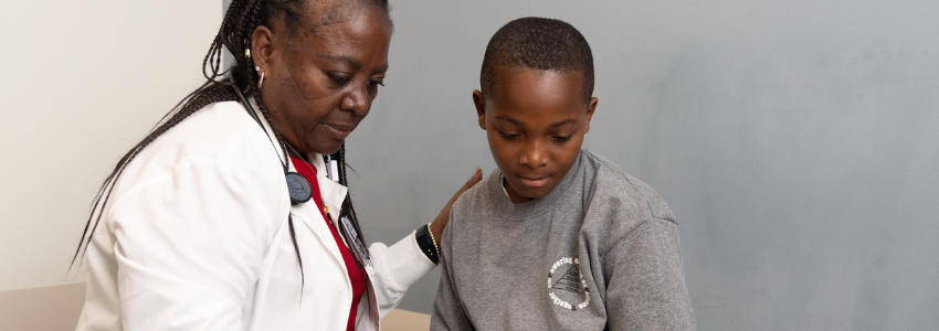 Nurse practitioner examines a young, male patient.