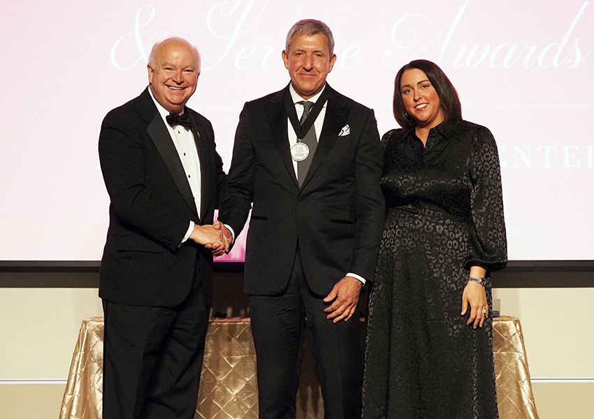 joe bonner and two others posing on stage