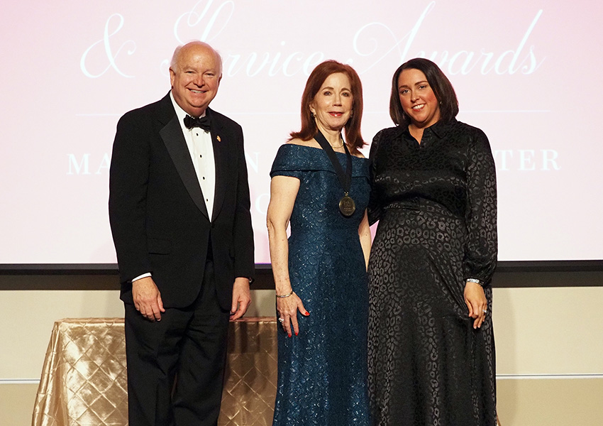 joe bonner and two others posing on stage