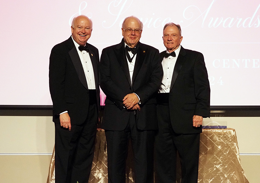 joe bonner and two others posing on stage