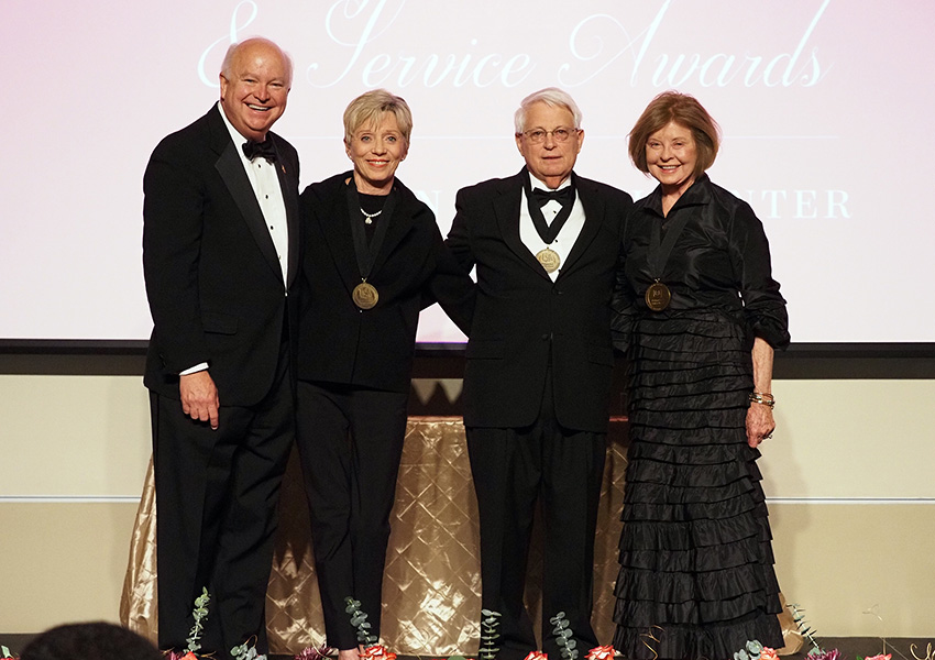 joe bonner and three others posing on stage