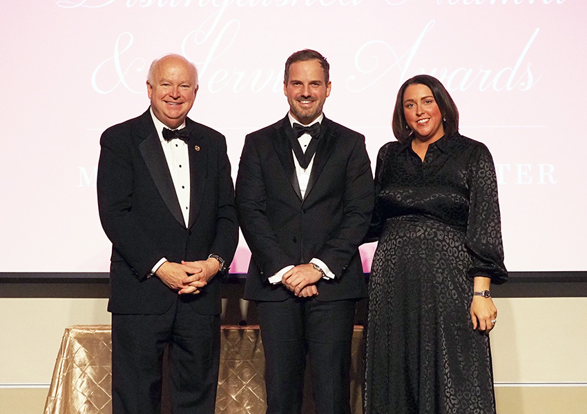 joe bonner and two others posing on stage