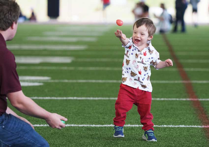 a young boy throwing an egg