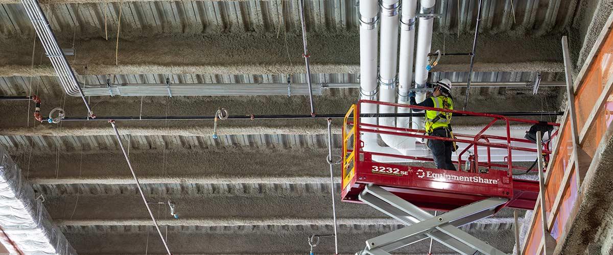 Worker at job site on lift