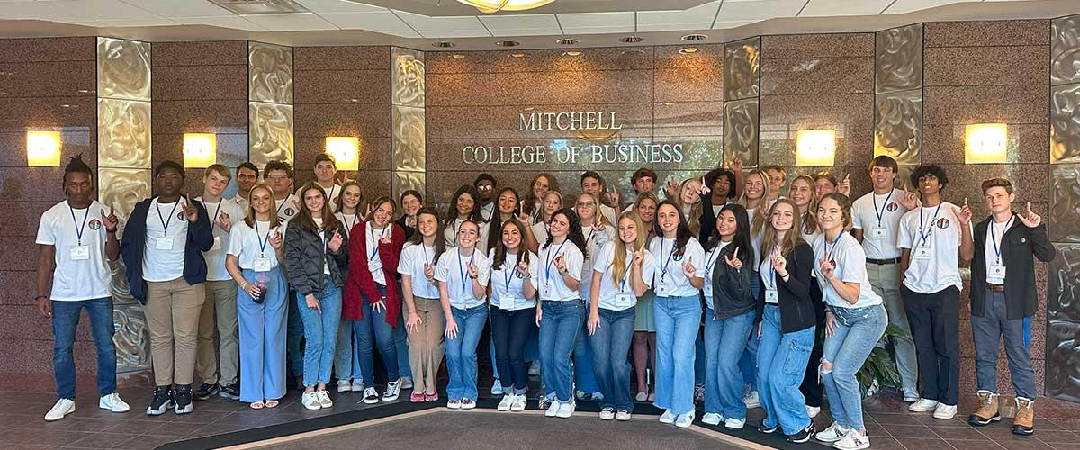 Student members taking a photo in the Mitchell College of Business