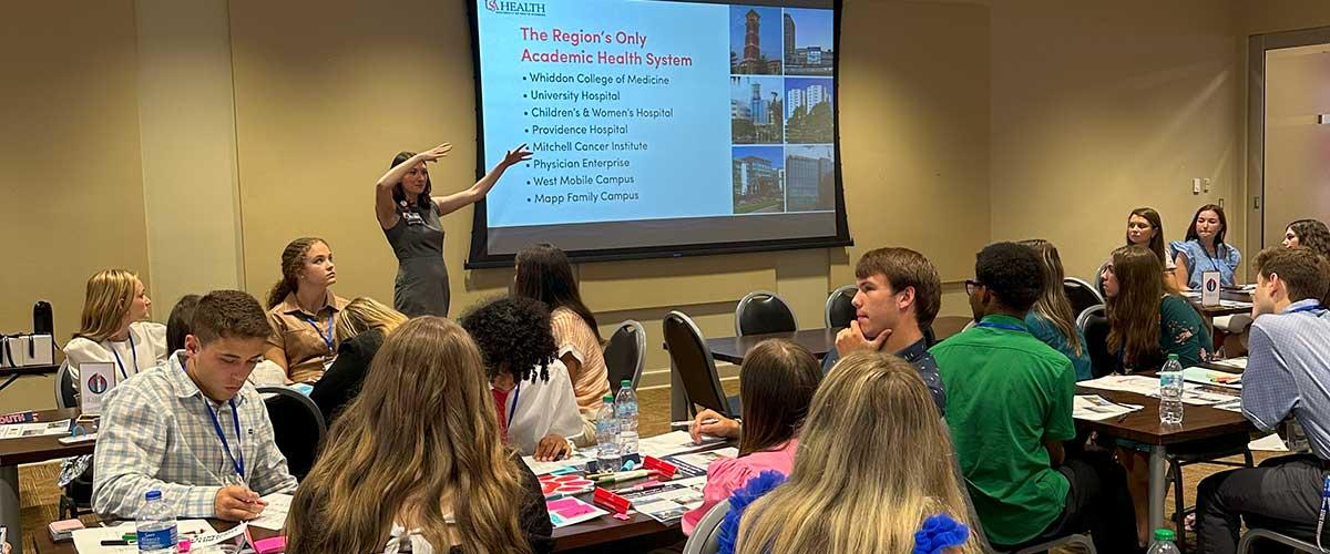 Students sitting for a presentation on South Alabama's "Academic Health System"