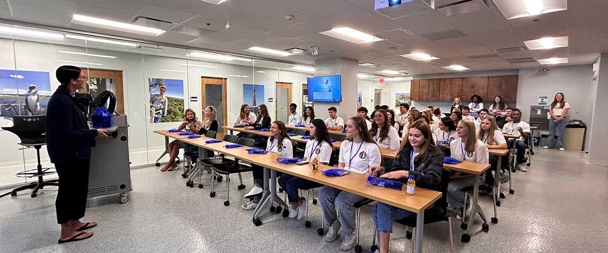 Students listen to a presenter for Class Session 1