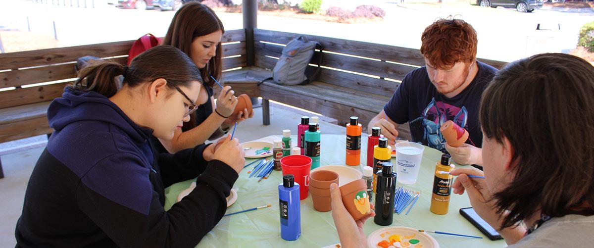 Group painting at table.