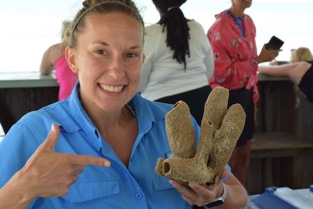 Molly Miller holding up coral.