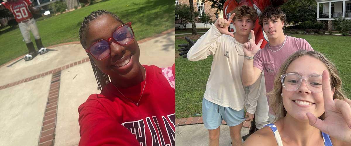 South Alabama Students posing in front of the South Paw statue on campus